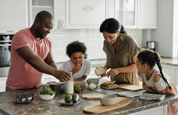 happy couple cooking because strong employee benefits make them secure
