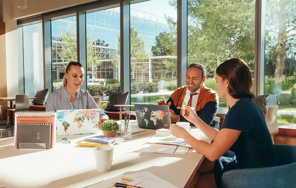 happy employees working in nice office with great employee benefits