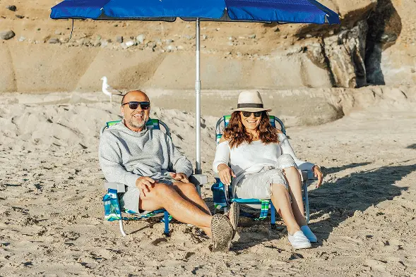retired people on sunny beach happy they got the best life insurance quotes