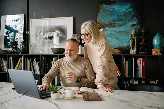 happy middle-aged couple reviewing their Medicare plan for their secure future