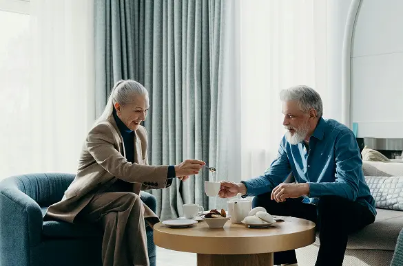 retired couple feeling secure retirement planning drinking tea safe from market volatility